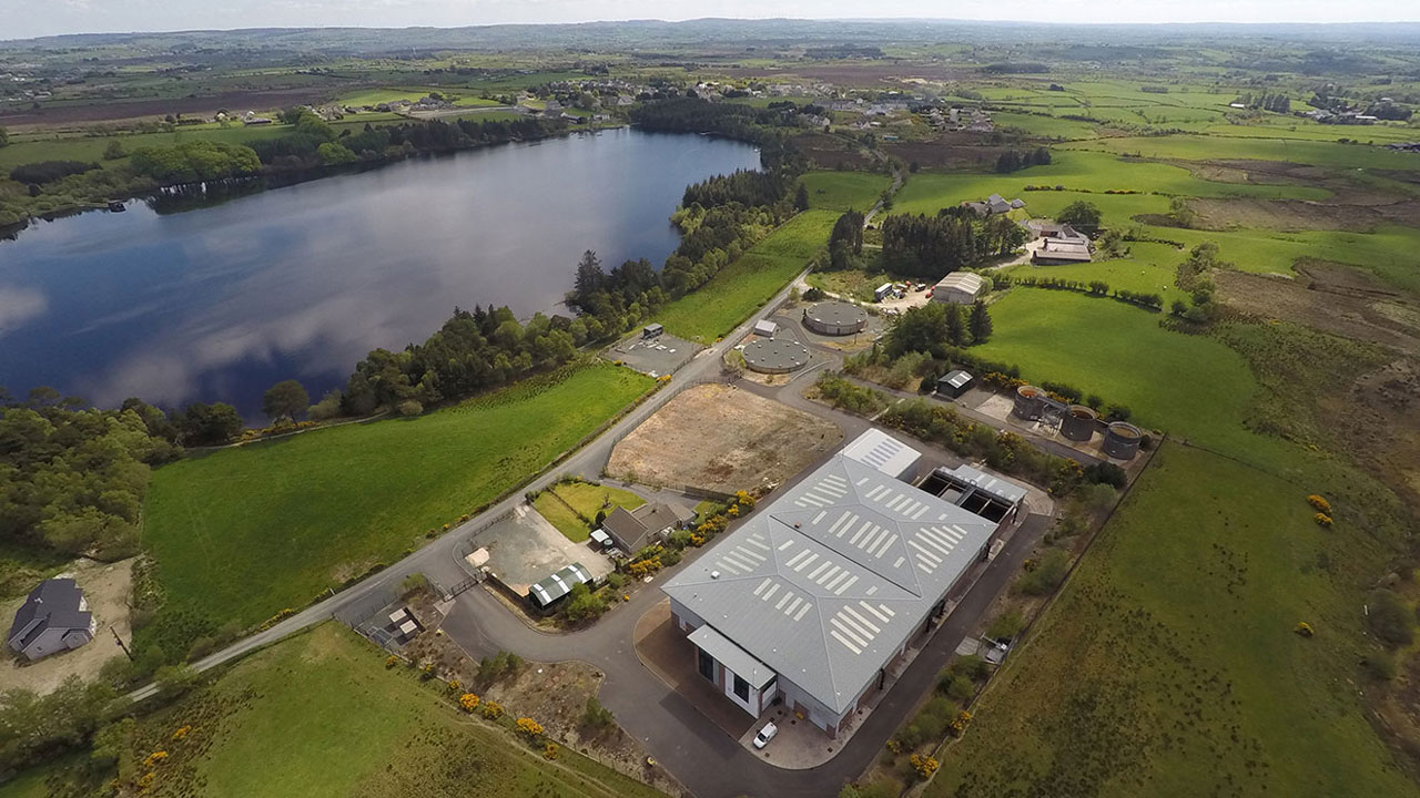Aerial view of water treatment infrastructure surrounded by green countryside